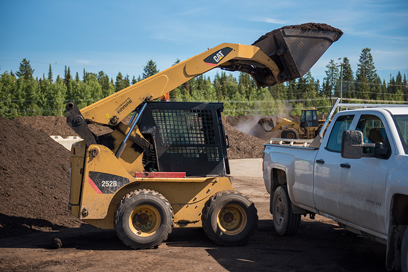 Compost being loaded into a pickup truck